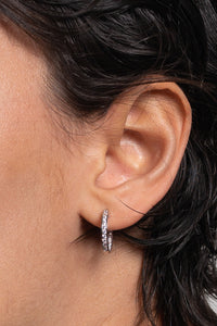 These middle-sized hoops are the perfect example of timeless elegance and of the moment jewelry. Featuring a shimmering and dainty style of pave setting. The Plaza Hoops will be the star that never goes out. These earrings are available in a smaller size.   Details:   Made in 14K Solid Yellow Gold With White Cubic Zirconia  Dimensions: L 1.8cm - W 1.8cm  Color: 14K Solid Yellow Gold / 14K Solid White Gold  Hypoallergenic   Fine Jewelry. miramira New York