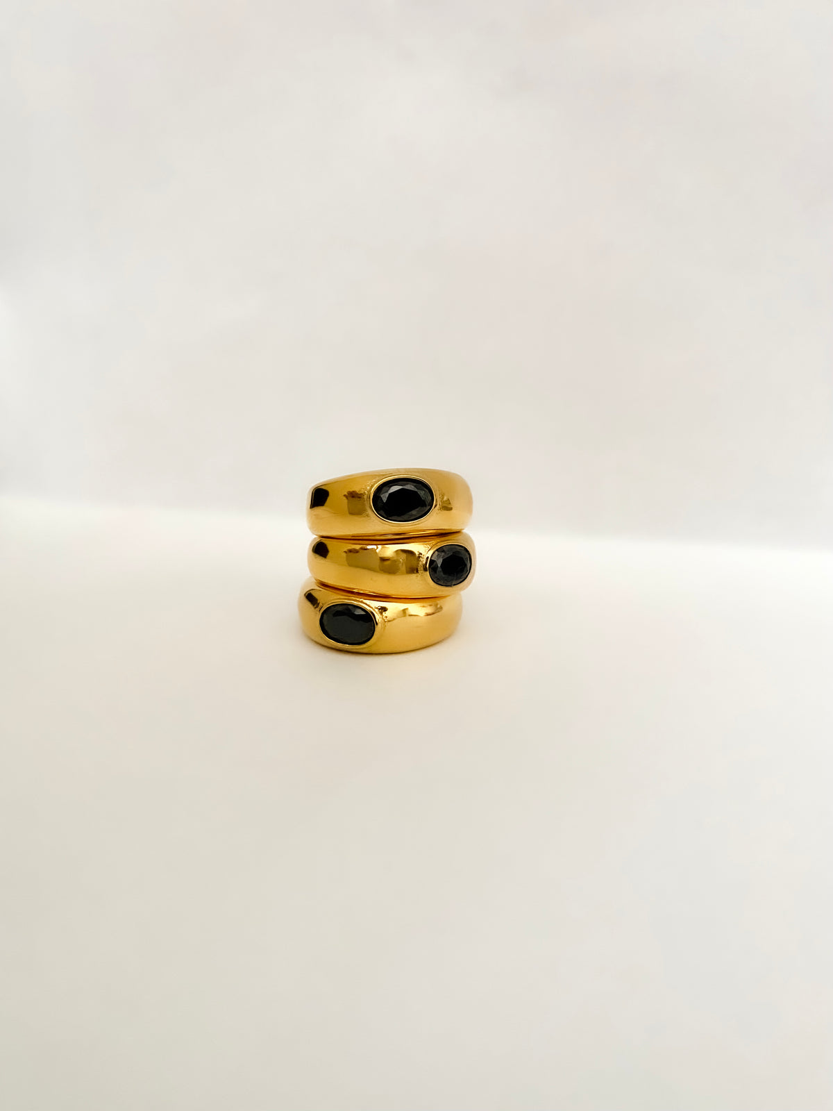 The perfect stainless steel ring accessory to impress those around you while running errands or on a date night. A delicate oval black stone centerpiece. A vintage and unisex design meant to be worn by all.    Details:  18K Gold Plated in Stainless Steel  Made in Stainless Steel  Black Gemstone  Available in US ring sizes 6, 7, and 8.  Weight about 7 g  Surface Width 4.5 mm