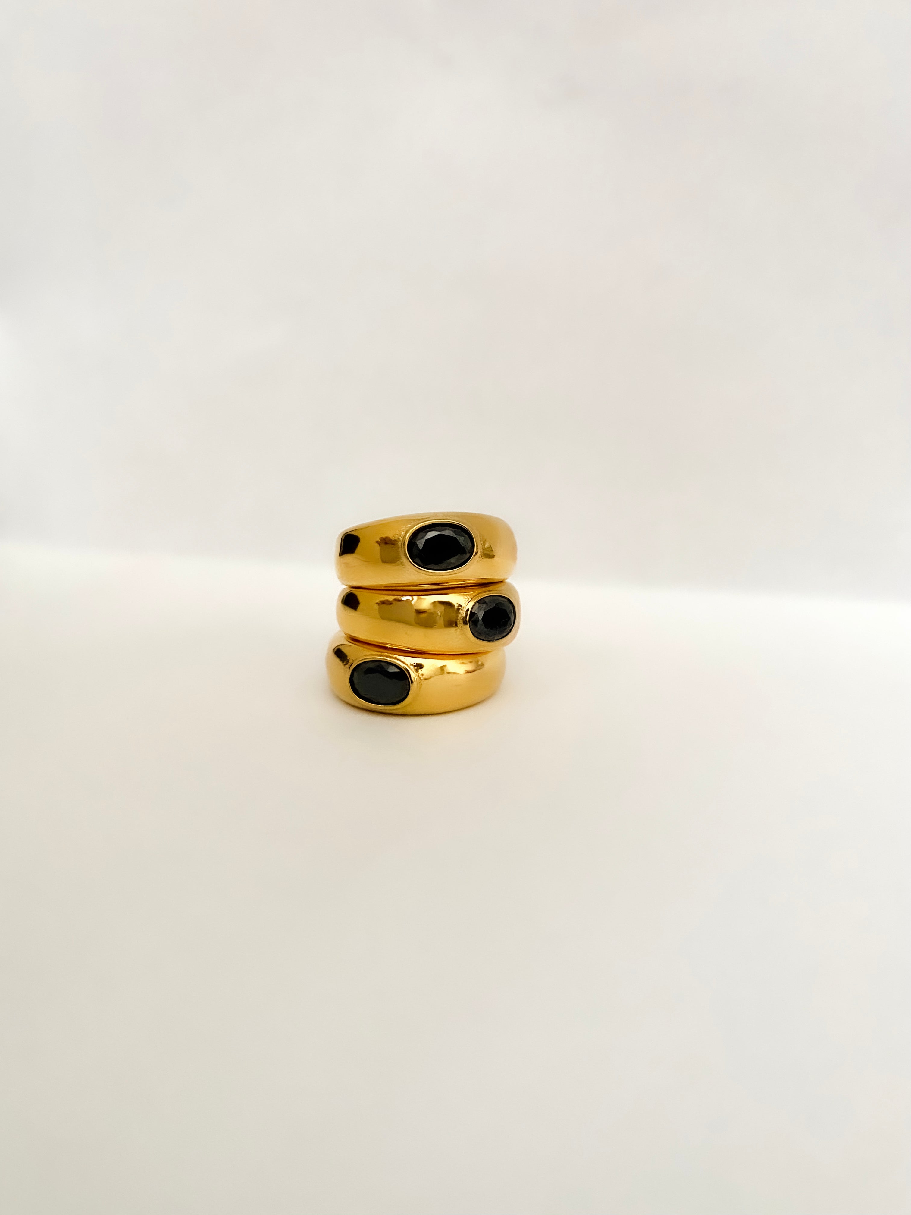 The perfect stainless steel ring accessory to impress those around you while running errands or on a date night. A delicate oval black stone centerpiece. A vintage and unisex design meant to be worn by all.    Details:  18K Gold Plated in Stainless Steel  Made in Stainless Steel  Black Gemstone  Available in US ring sizes 6, 7, and 8.  Weight about 7 g  Surface Width 4.5 mm