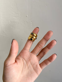 The perfect stainless steel ring accessory to impress those around you while running errands or on a date night. A delicate oval black stone centerpiece. A vintage and unisex design meant to be worn by all.    Details:  18K Gold Plated in Stainless Steel  Made in Stainless Steel  Black Gemstone  Available in US ring sizes 6, 7, and 8.  Weight about 7 g  Surface Width 4.5 mm
