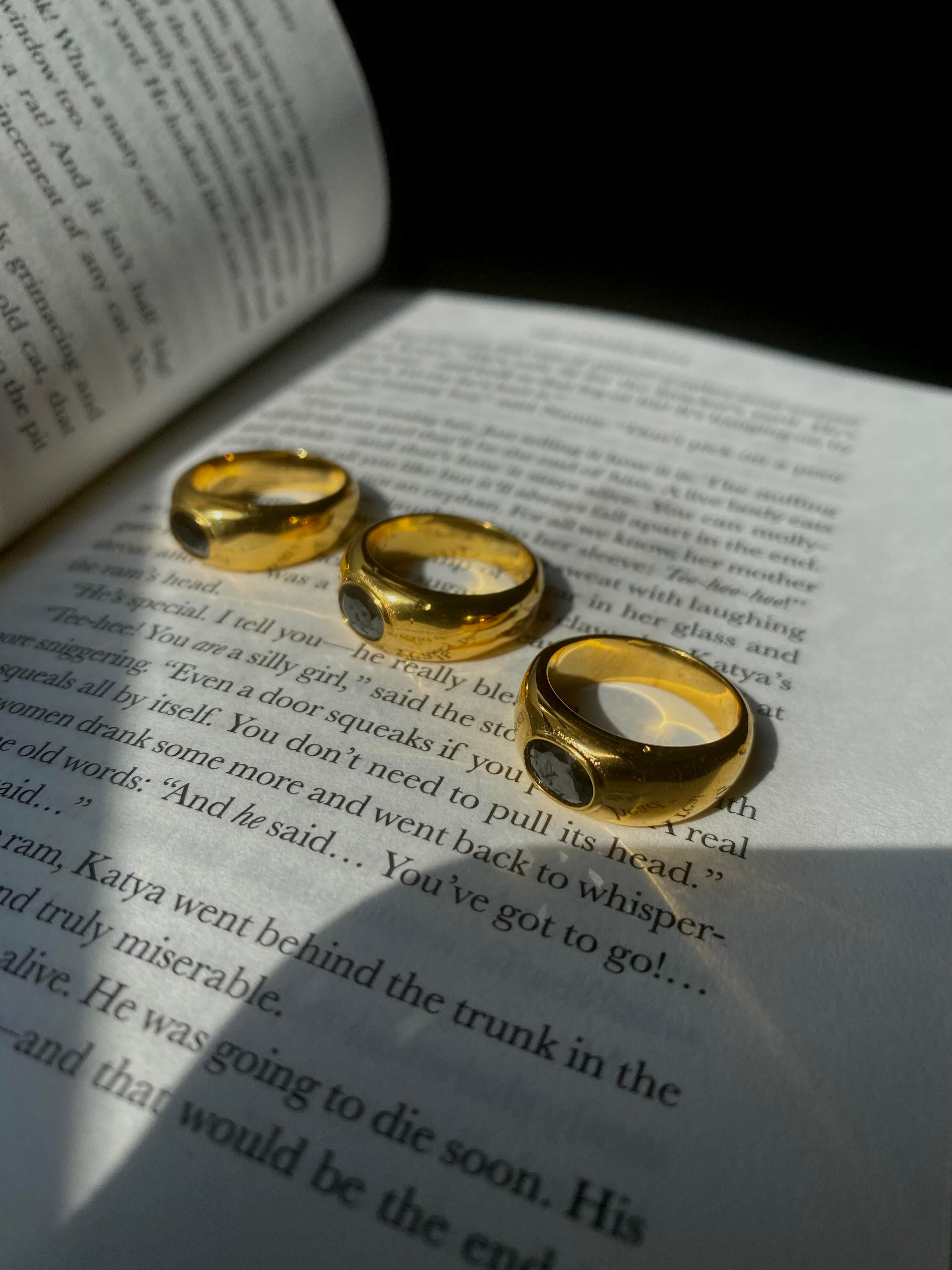 The perfect stainless steel ring accessory to impress those around you while running errands or on a date night. A delicate oval black stone centerpiece. A vintage and unisex design meant to be worn by all.    Details:  18K Gold Plated in Stainless Steel  Made in Stainless Steel  Black Gemstone  Available in US ring sizes 6, 7, and 8.  Weight about 7 g  Surface Width 4.5 mm